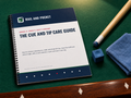 The Cue and Tip Care Guide printed booklet on a pool table with a cue shaft, chalk and a cloth